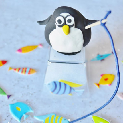 Use clay to recreate this winter penguin ice fishing scene