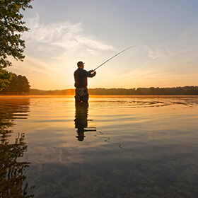 Man fishing at dusk