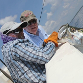 fishing charter and angler fishing together