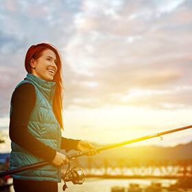 Woman fishing during sunset