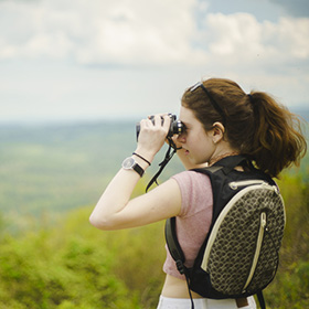 Girl at national park looking through binoculars
