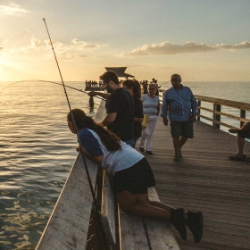 family fishing from a pier following pier fishing tips