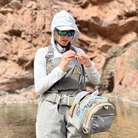 Woman tying a fly for fly fishing