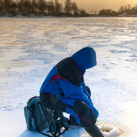 Angler with his ice fishing safety equipment and ice safety picks