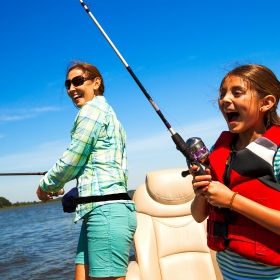 mon and daugther fishing during national fishing and boating week